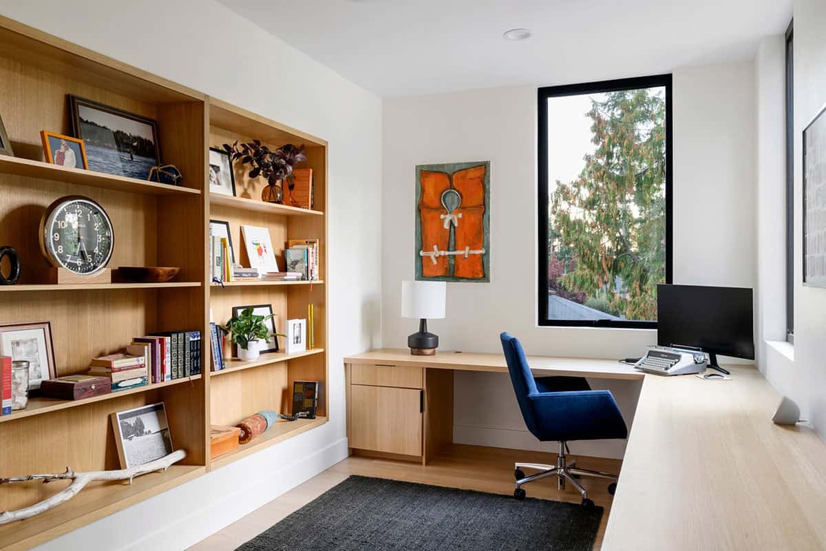 Home office with built-in shelving desk and blue task chair