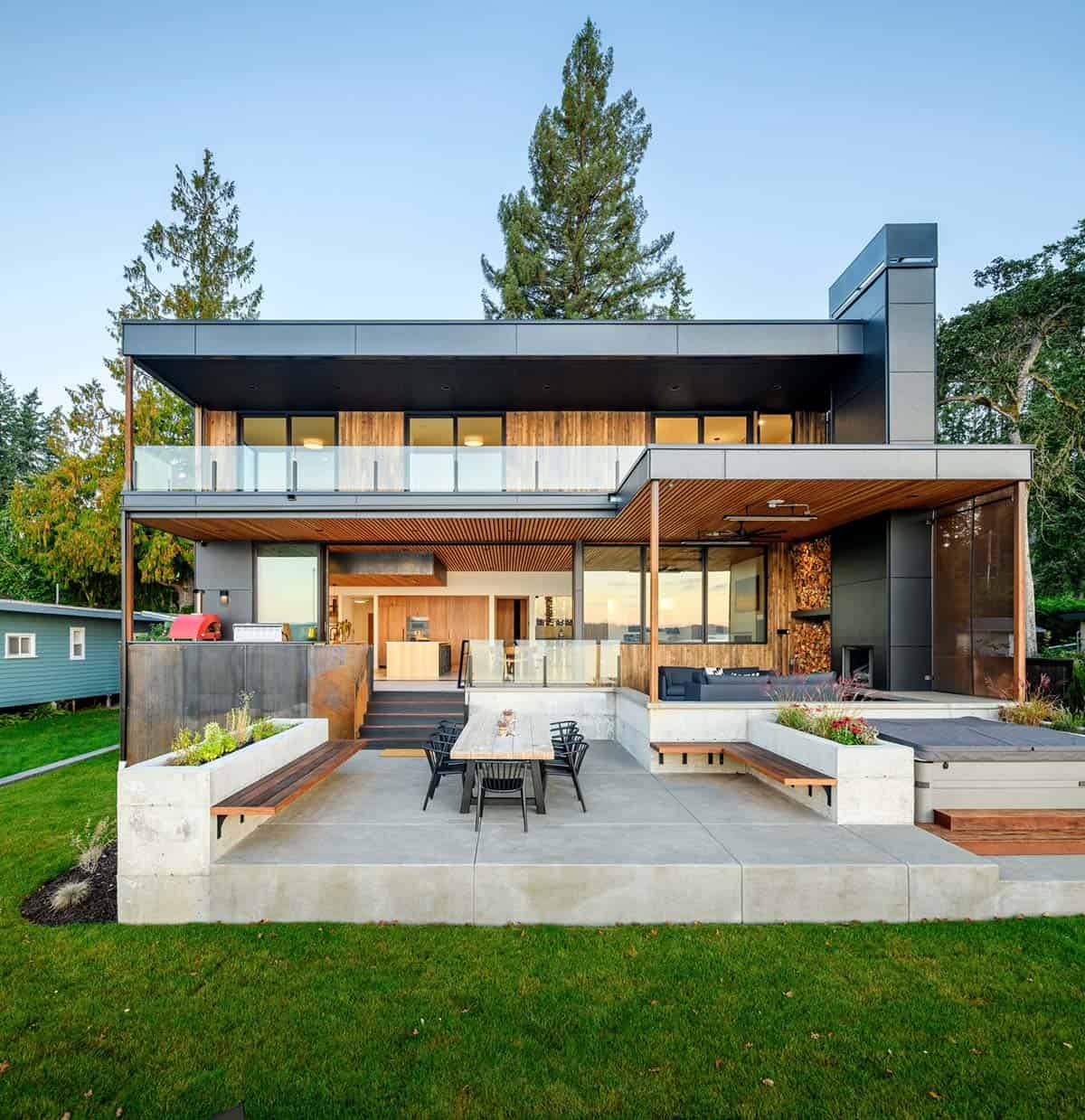 Rear facade with covered patio dining area and green lawn