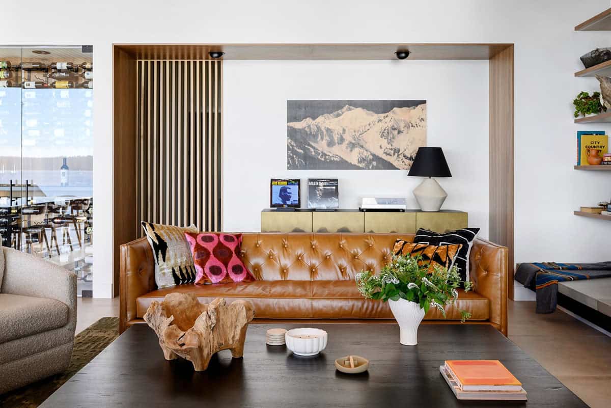 Leather sofa nook with mountain art and brass record cabinet
