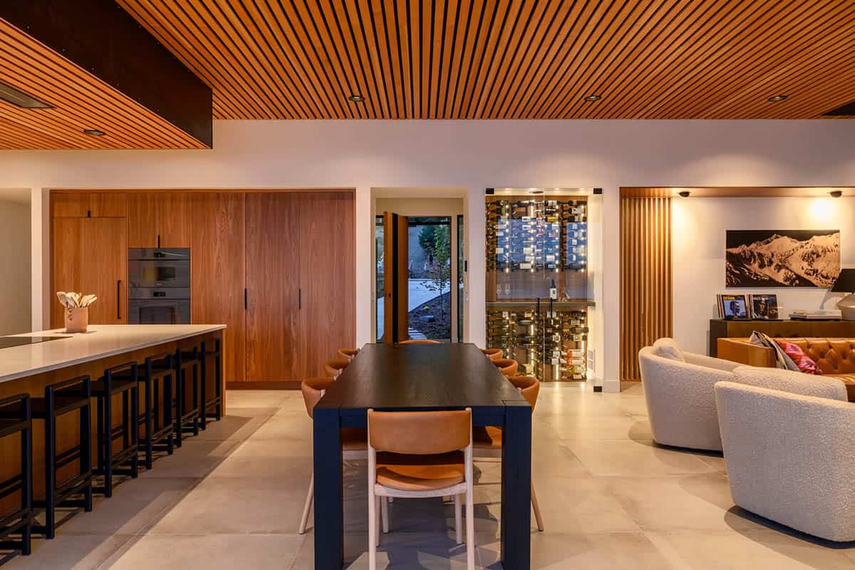 Dark wood dining nook with wine display and mountain art
