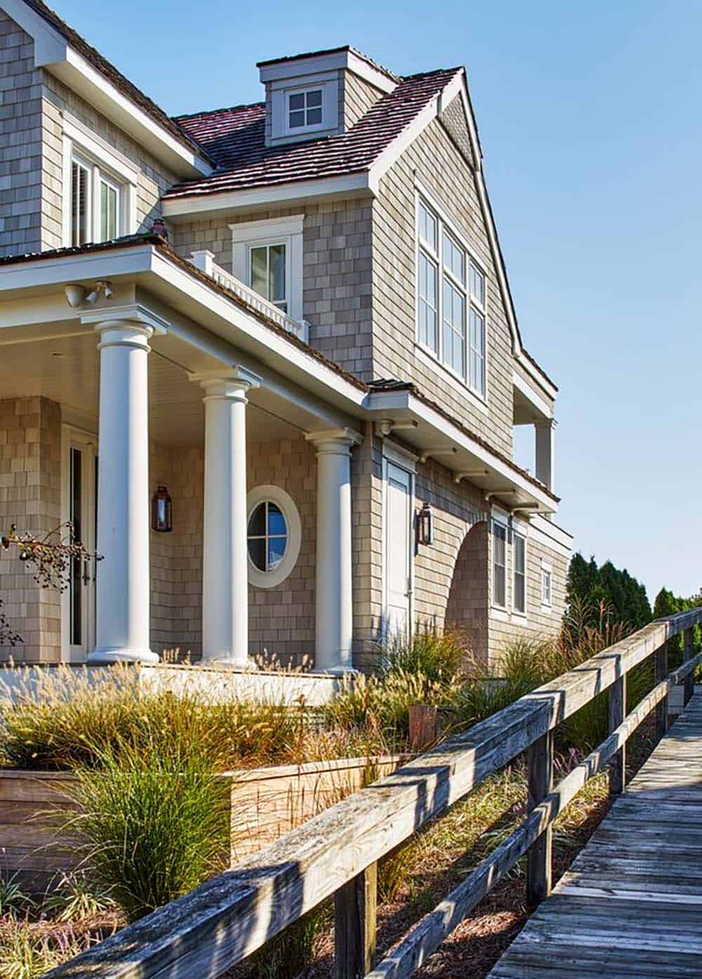 Front porch columns and gambrel dormer along the boardwalk approach