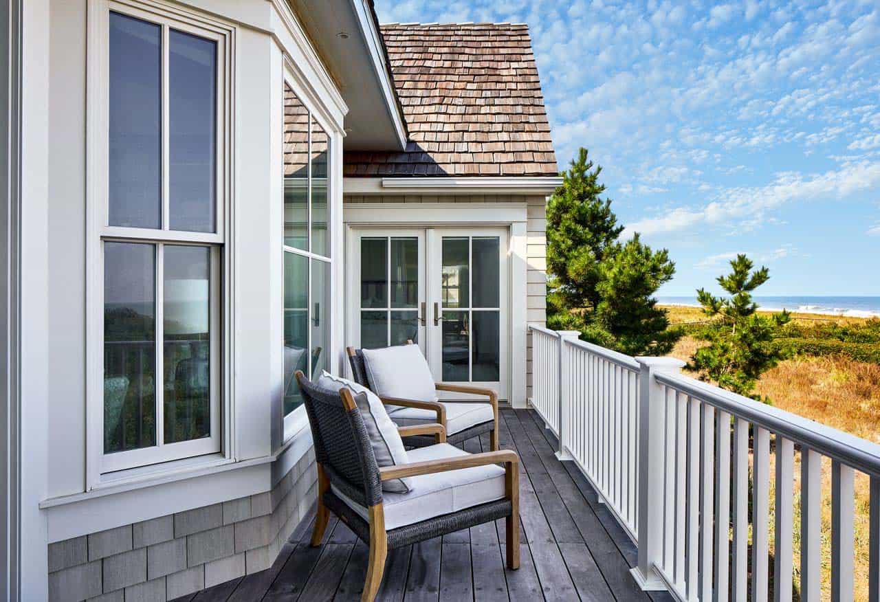 Upper deck seating framed by dune grass and ocean view