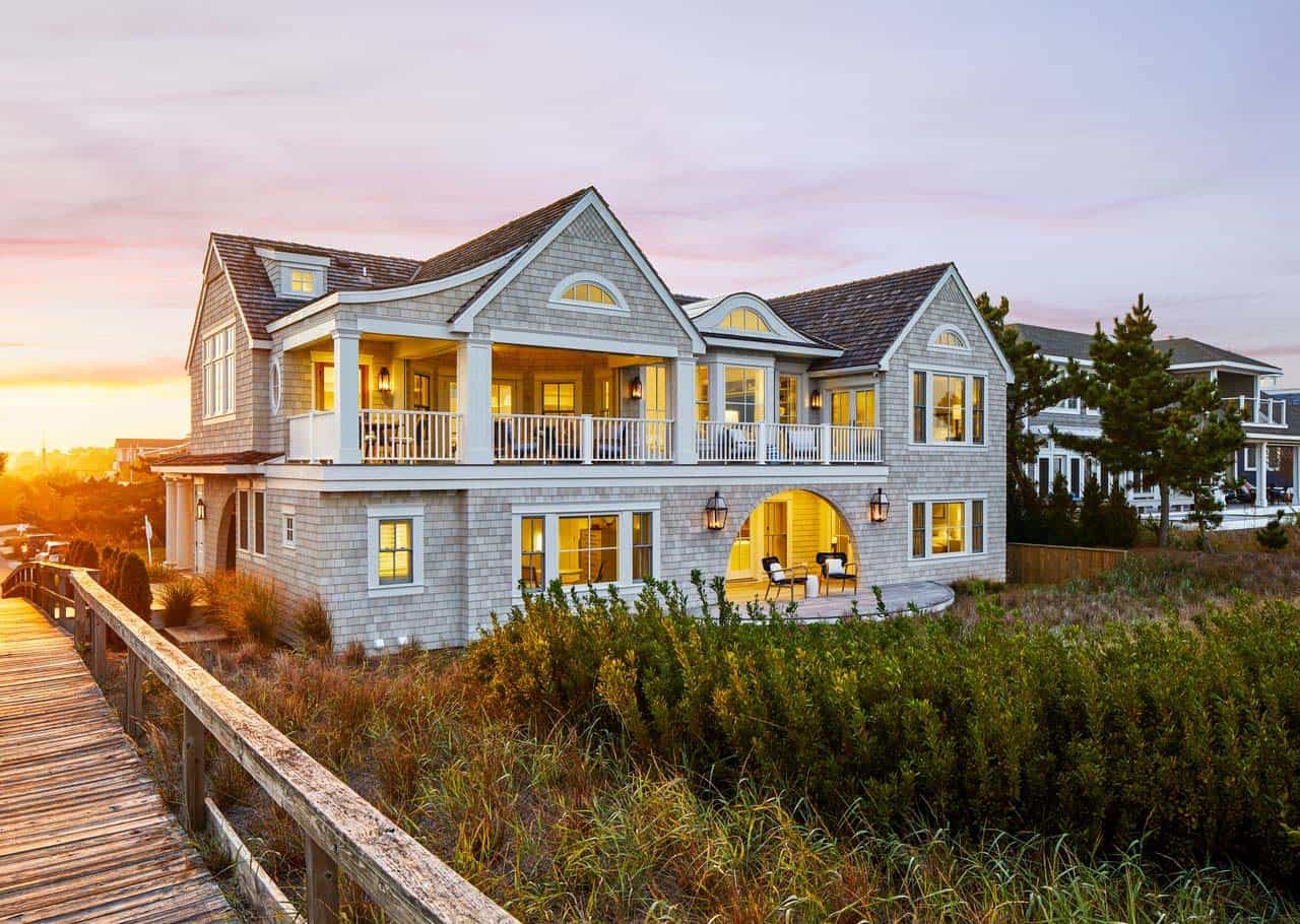 Dusk view of the home's layered porches and gables