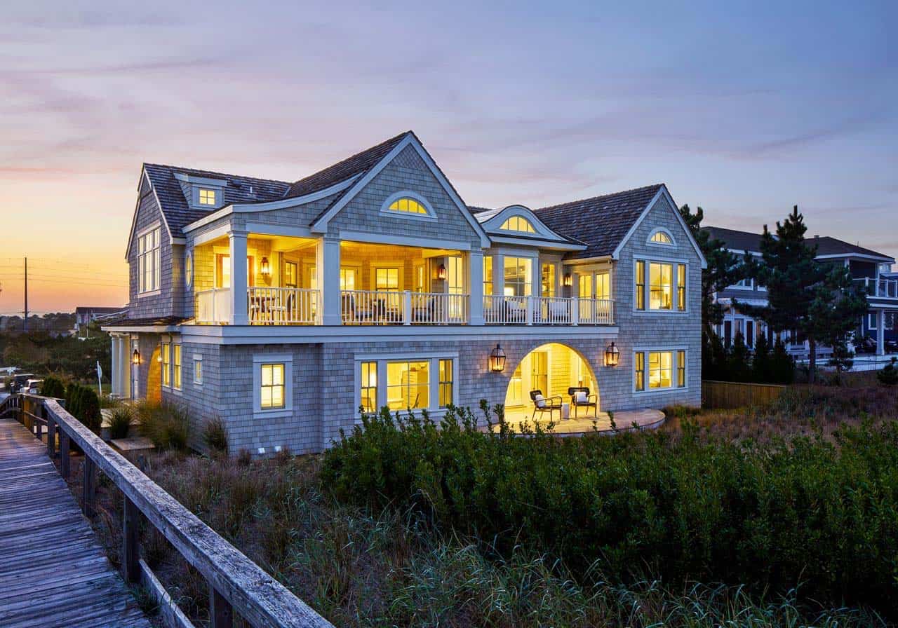 Illuminated rear exterior at dusk with arched patio below