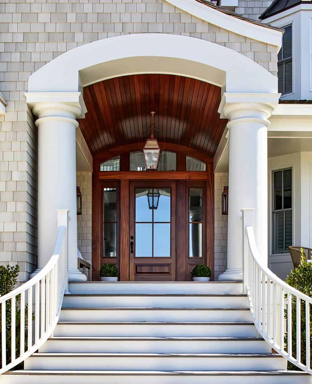 Vaulted wood entry portico with mahogany door and lantern