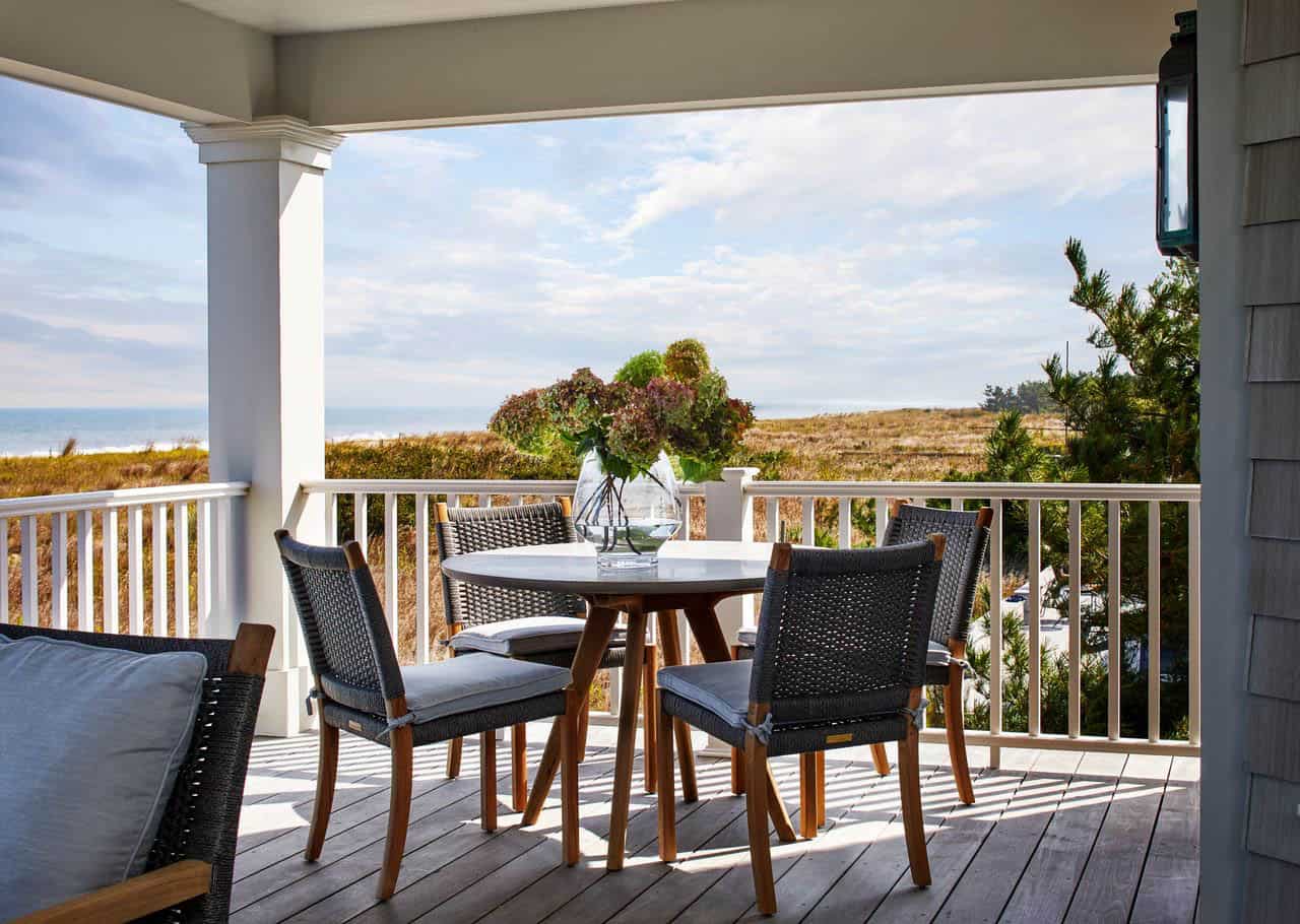 Covered porch dining table set for an ocean-view breakfast