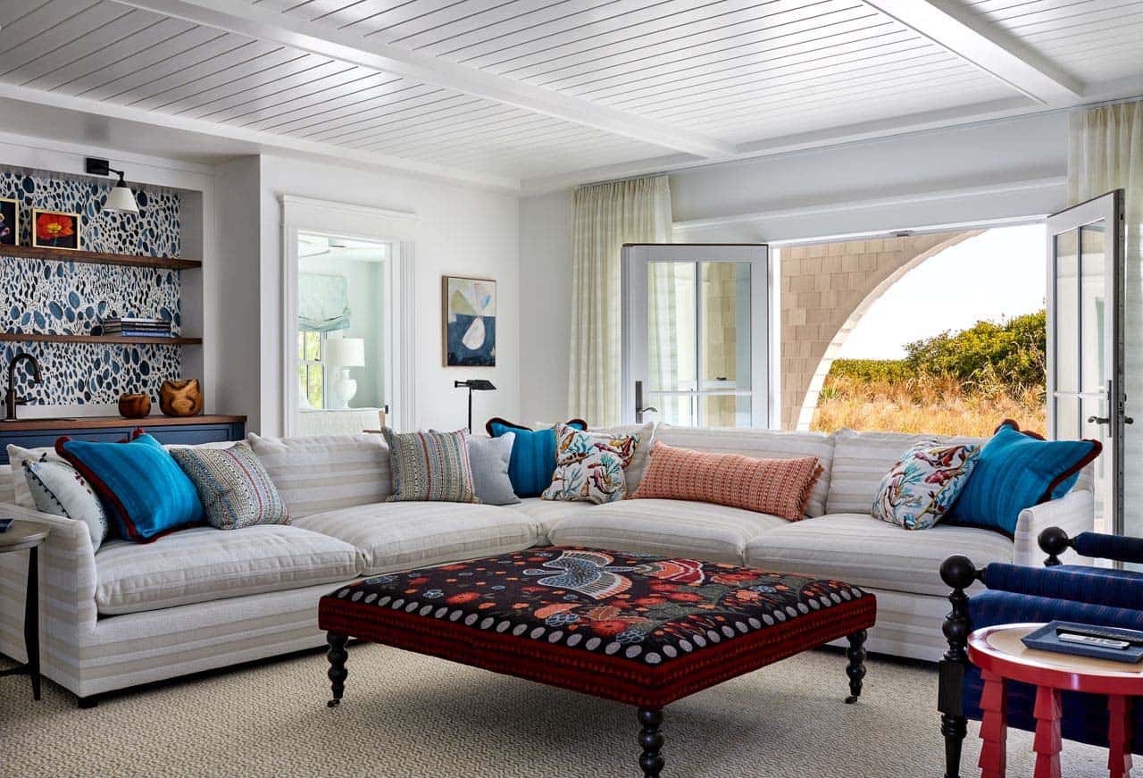 Sectional sofa with colorful pillows opening to arched patio