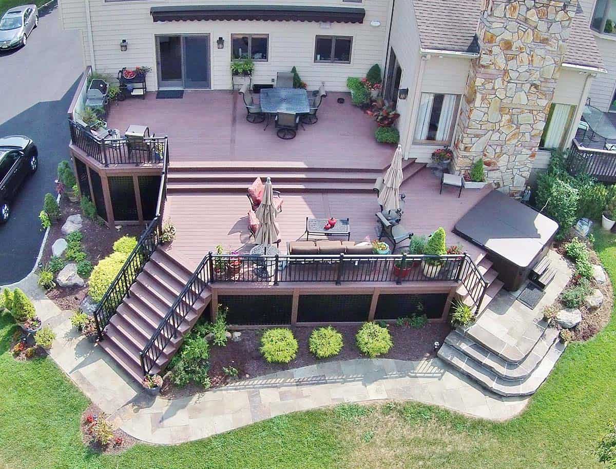 Aerial view of multi-level PVC deck in Wyckoff, New Jersey with dining area, lounge, and semi-sunken hot tub