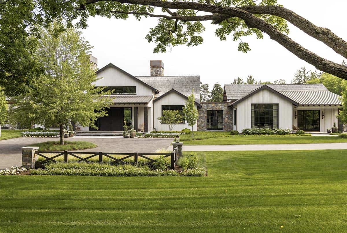 Front elevation showing multiple gabled rooflines, stone accents, and dark-framed windows