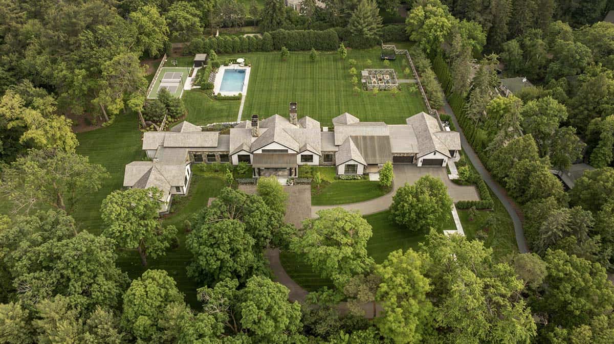 Aerial view of the estate showing the house layout, pool, and surrounding tree canopy