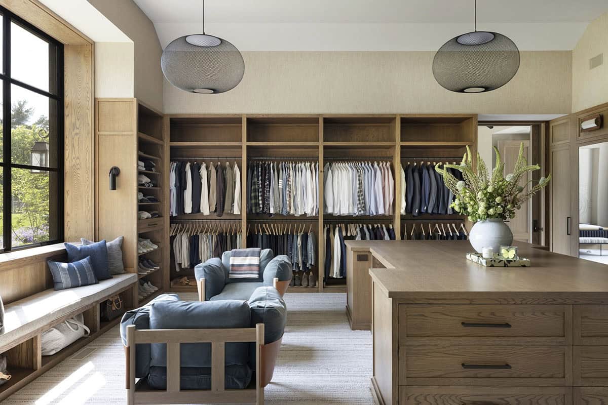 Walk-in closet with wood shelving, center island, mesh pendant lights, and built-in window seat