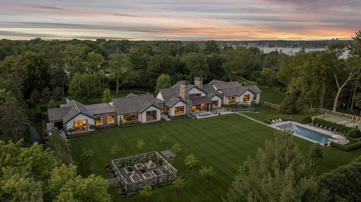 Aerial dusk view of the estate showing the house, gardens, and distant lake