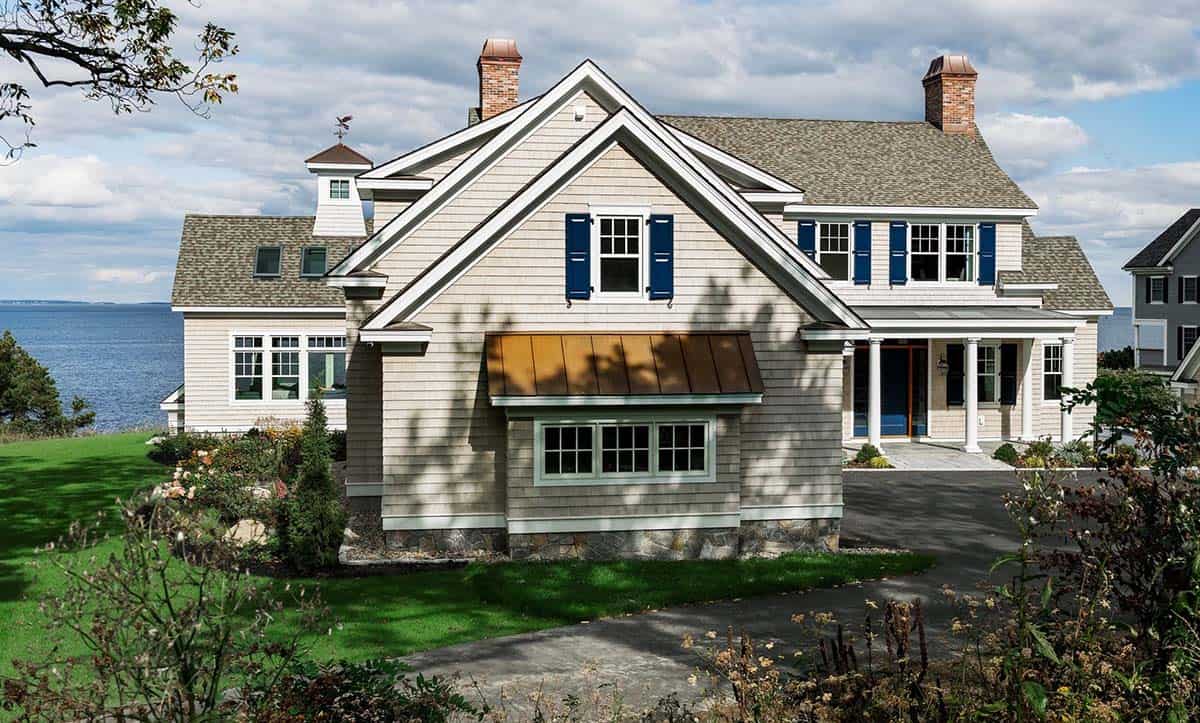 Side view of shingle-style home with cupola, weathervane, and ocean view
