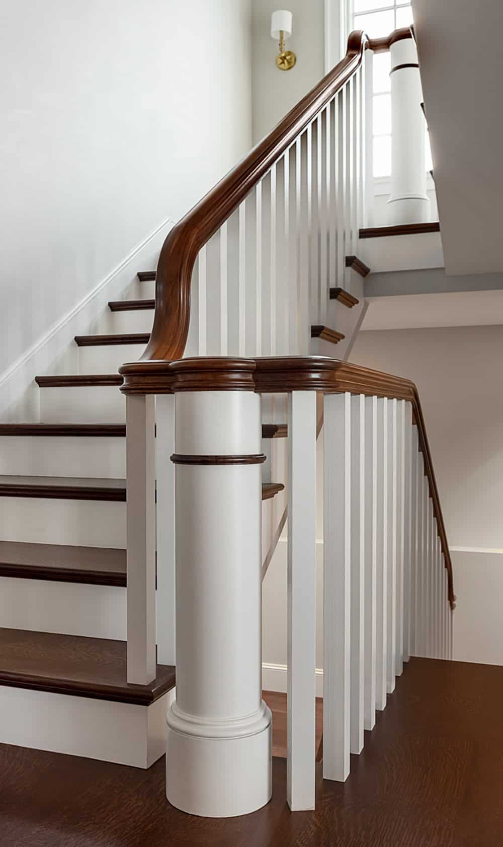 Staircase detail with white balusters and dark wood handrail