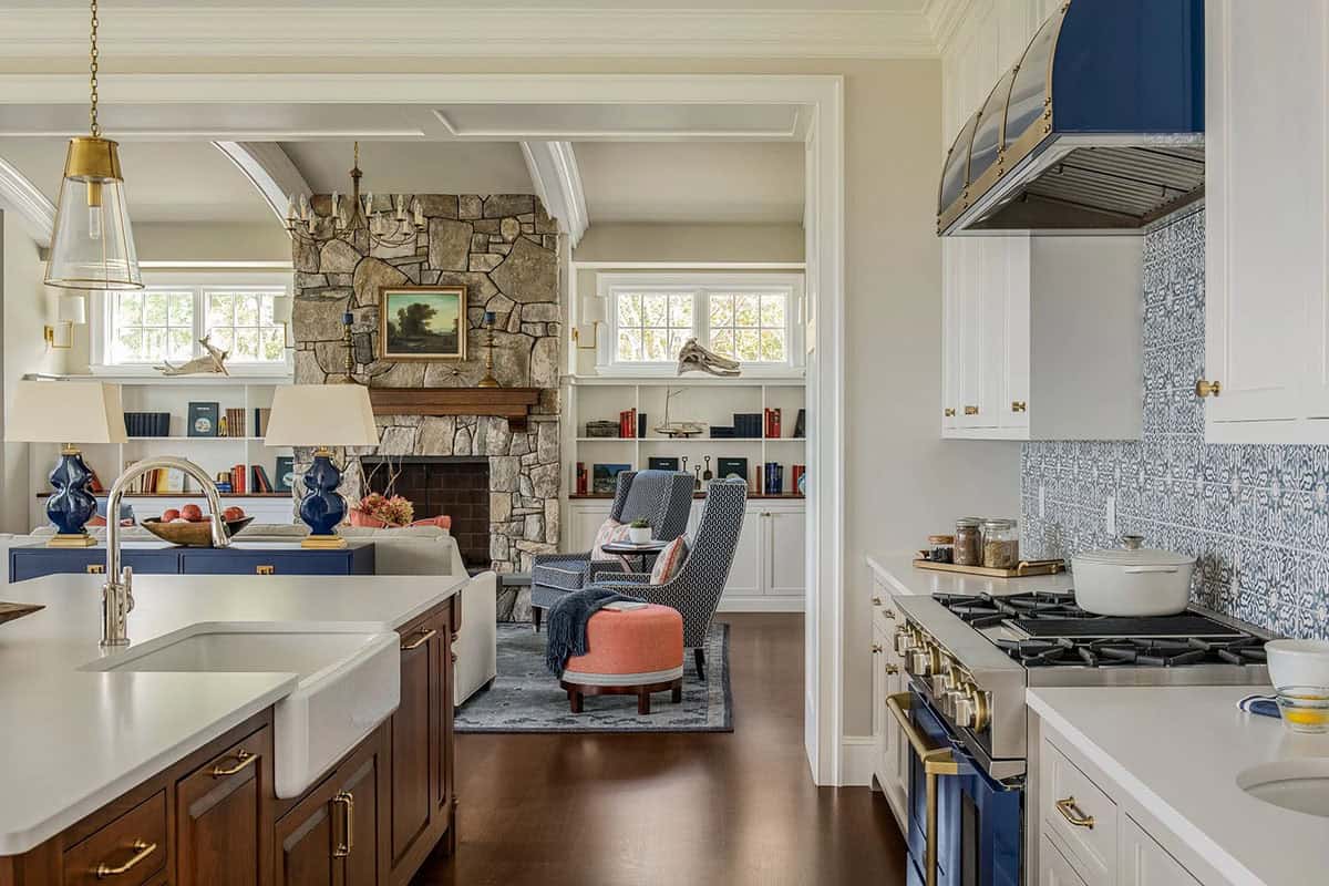 Kitchen island view into living room with stone fireplace