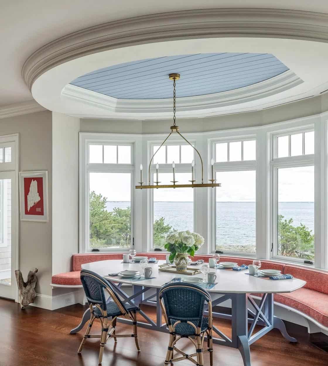 Curved breakfast nook with oval ceiling detail and panoramic ocean windows