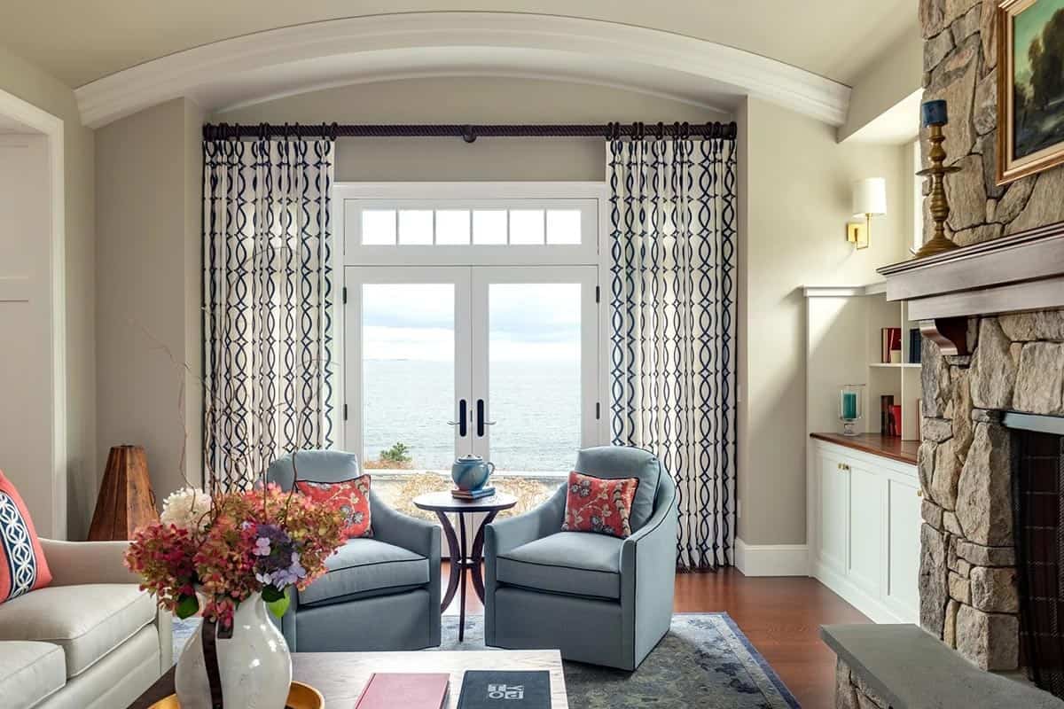 Living room seating nook with arched doorway framing an ocean view