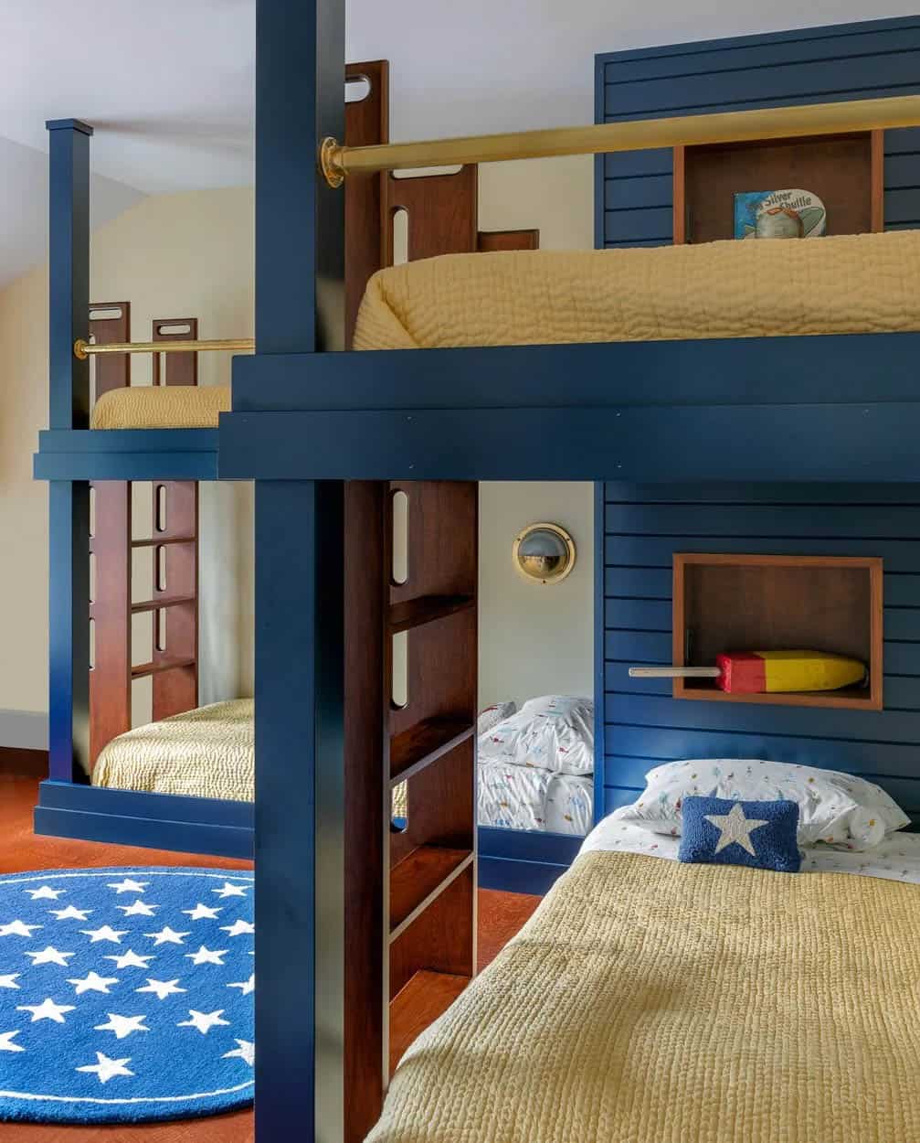 Close-up of navy bunk bed frame with wood ladder and brass porthole