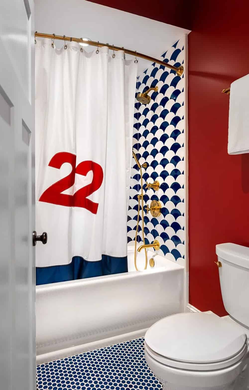 Bathtub with red "22" sail-print shower curtain and scallop tile