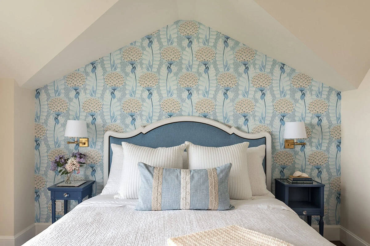 Bedroom with peaked ceiling and blue-and-white floral wallpaper accent