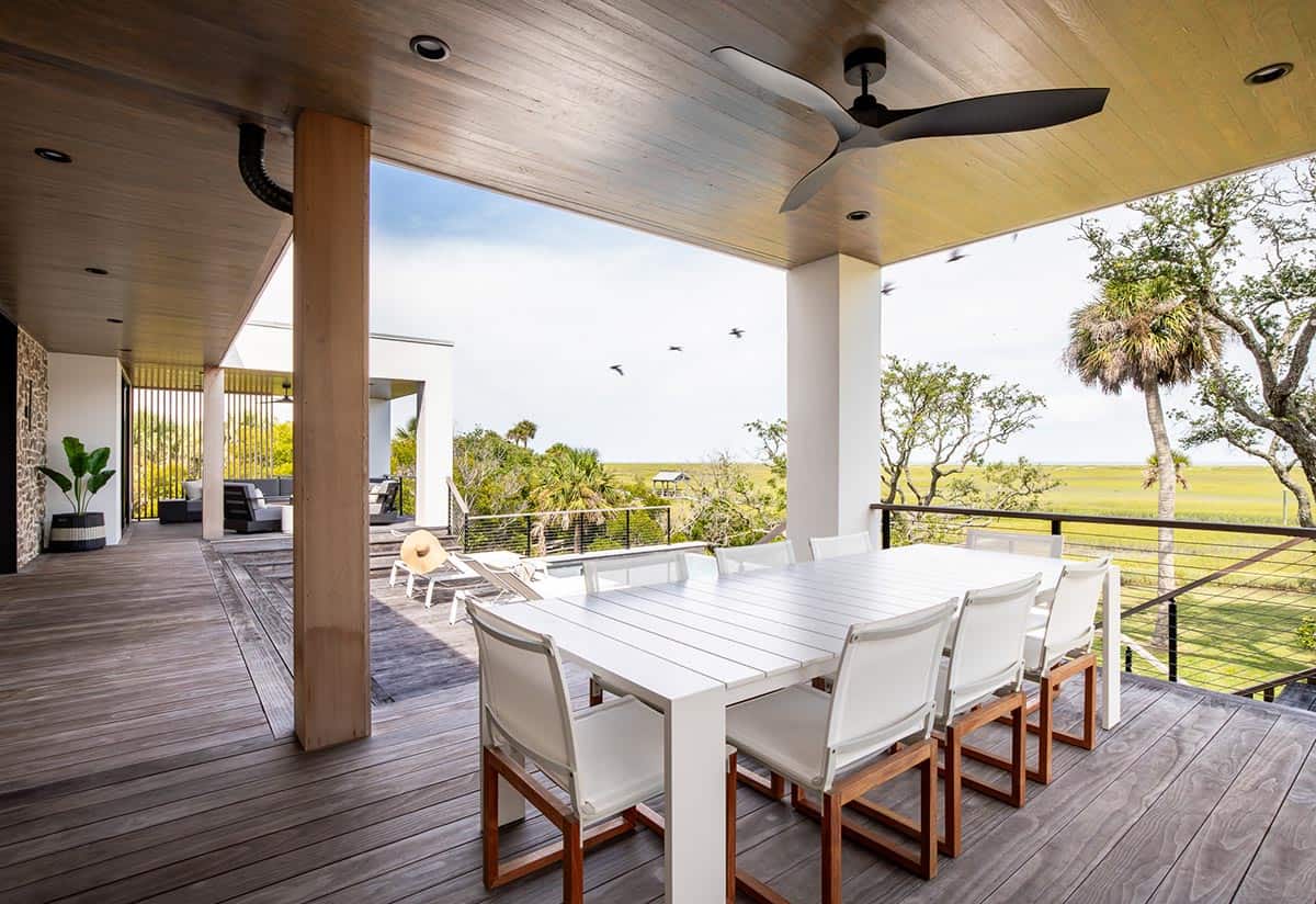 Covered outdoor dining deck with wood ceiling and marsh views