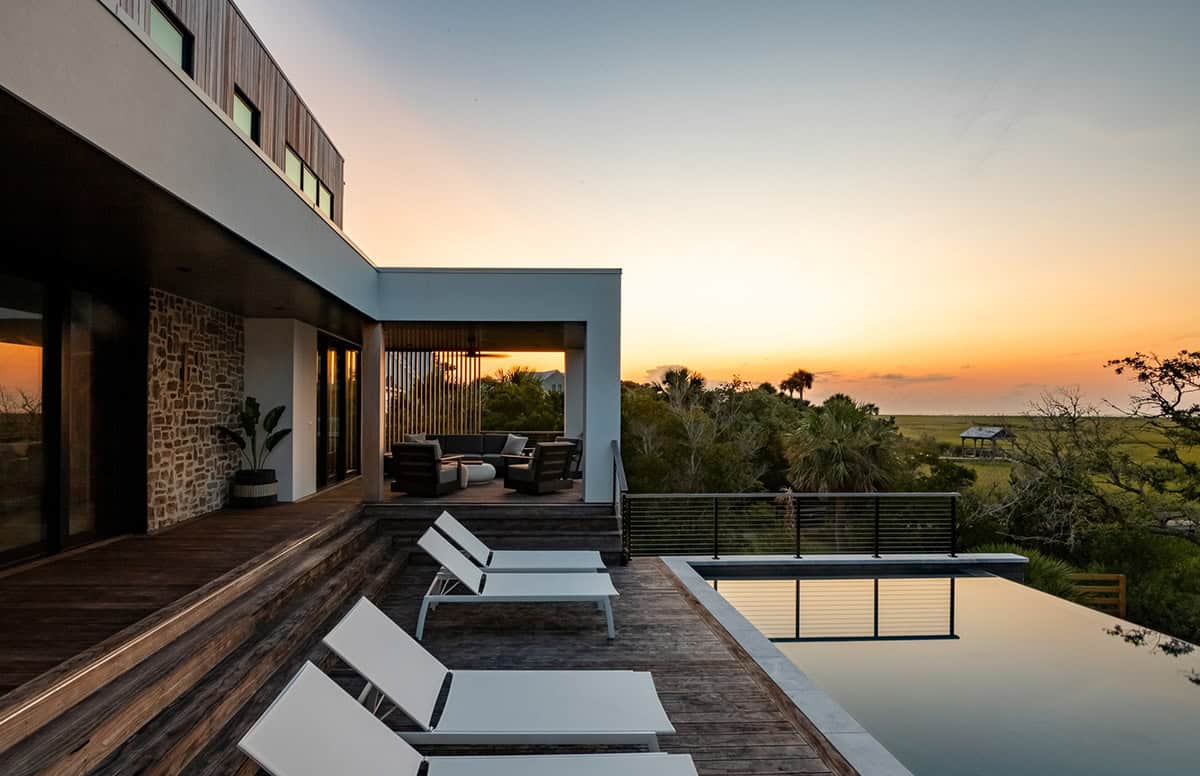 Rooftop lounge deck with infinity pool at sunset