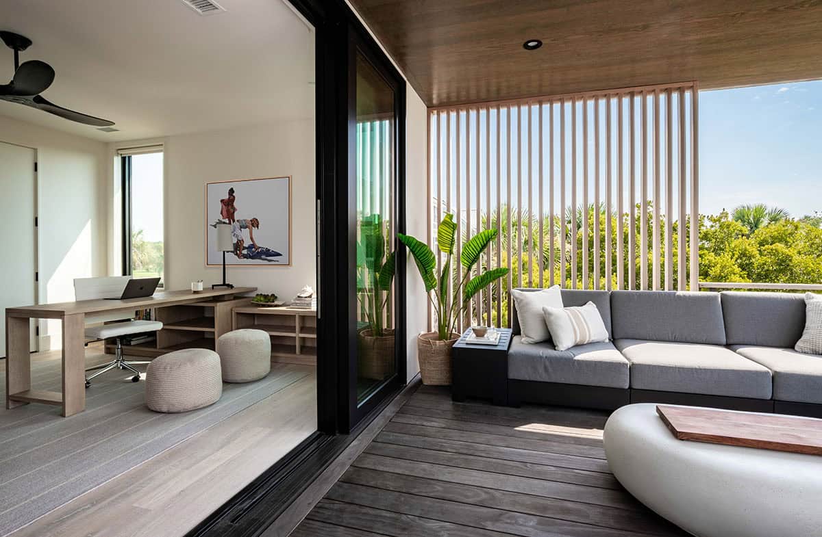 Home office with slatted wood screen opening to covered balcony seating