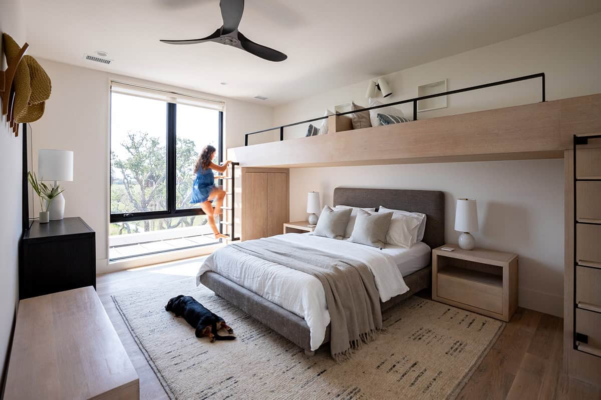 Bedroom with built-in loft bunk, sleeping dog, and marsh view