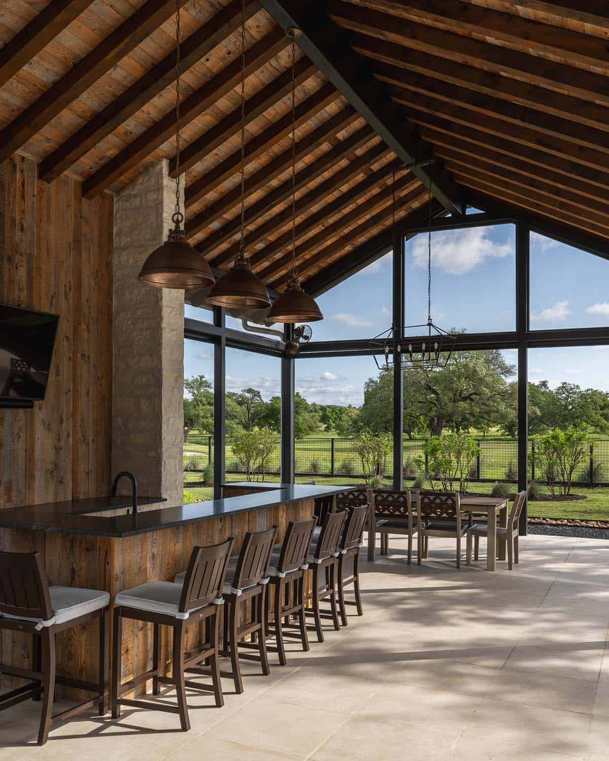 Covered outdoor bar with reclaimed wood ceiling and copper pendant lights
