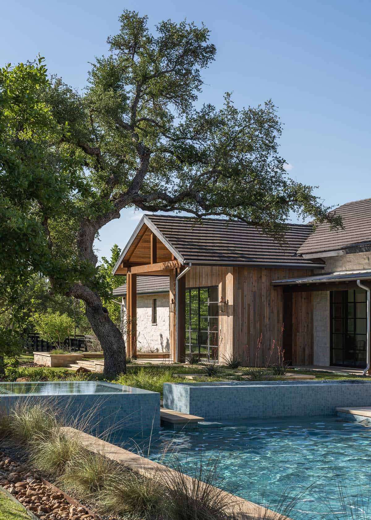 Infinity-edge spa and pool beside wood-sided guest wing