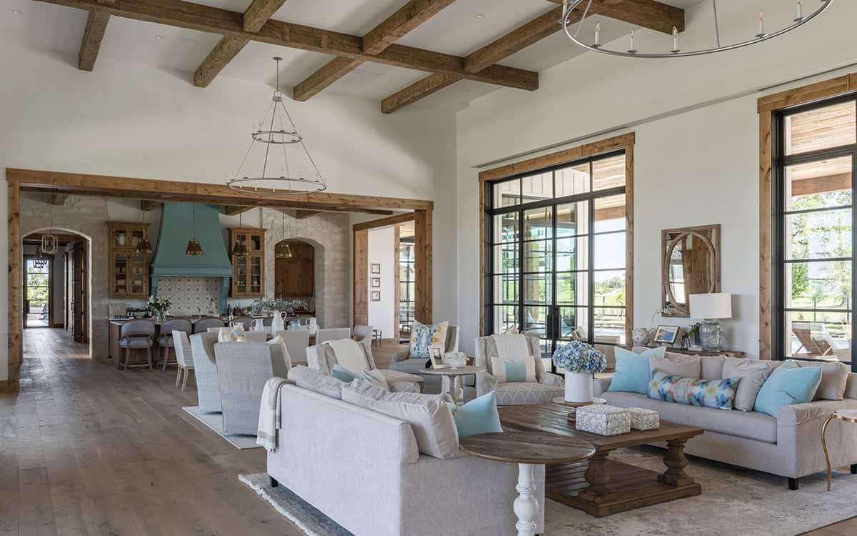 Open living area with beamed ceiling and French doors to the patio
