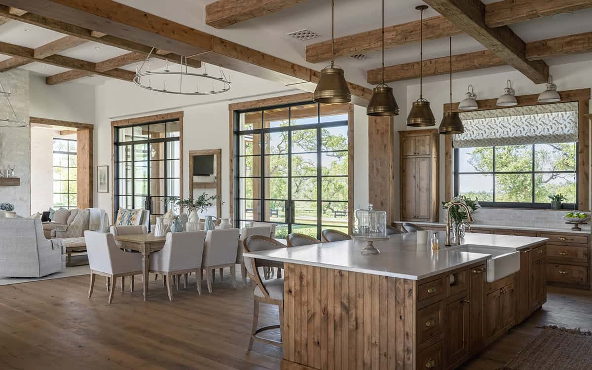 Kitchen and dining area with reclaimed wood beams and steel-framed windows