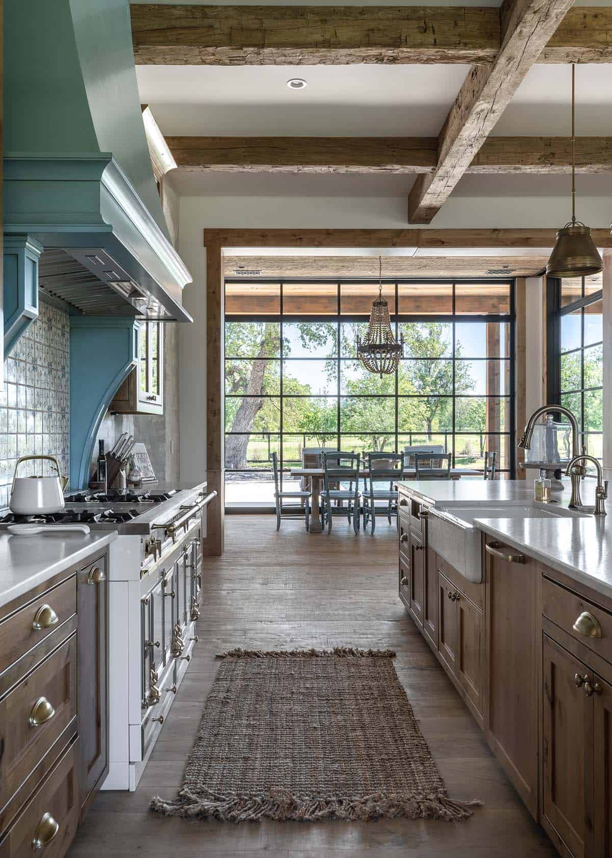 Kitchen galley view toward dining nook with a large window
