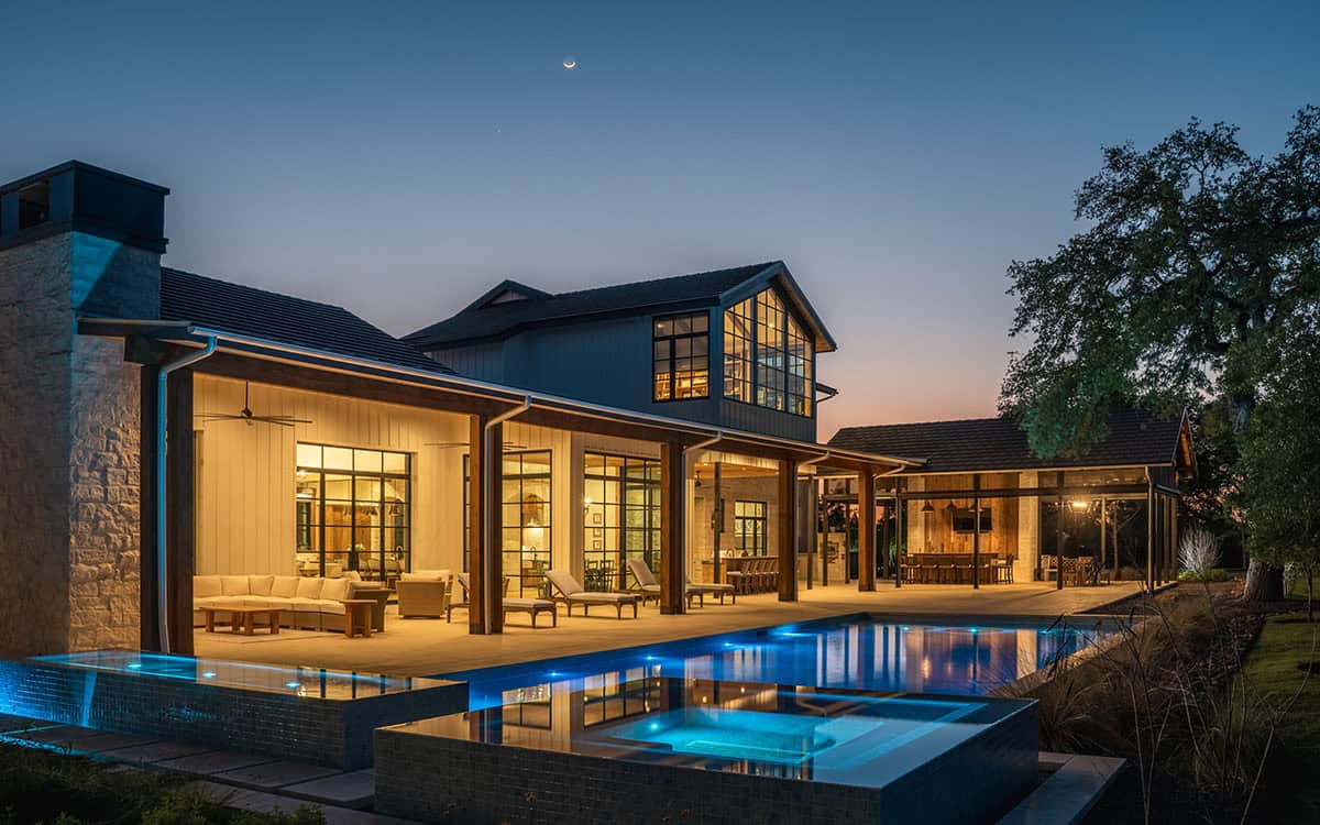 Pool deck with covered outdoor living at dusk
