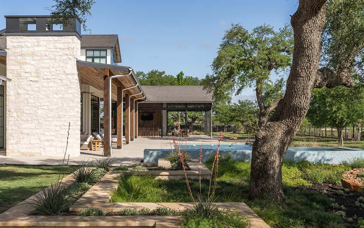 Stone home exterior with covered patio and infinity spa