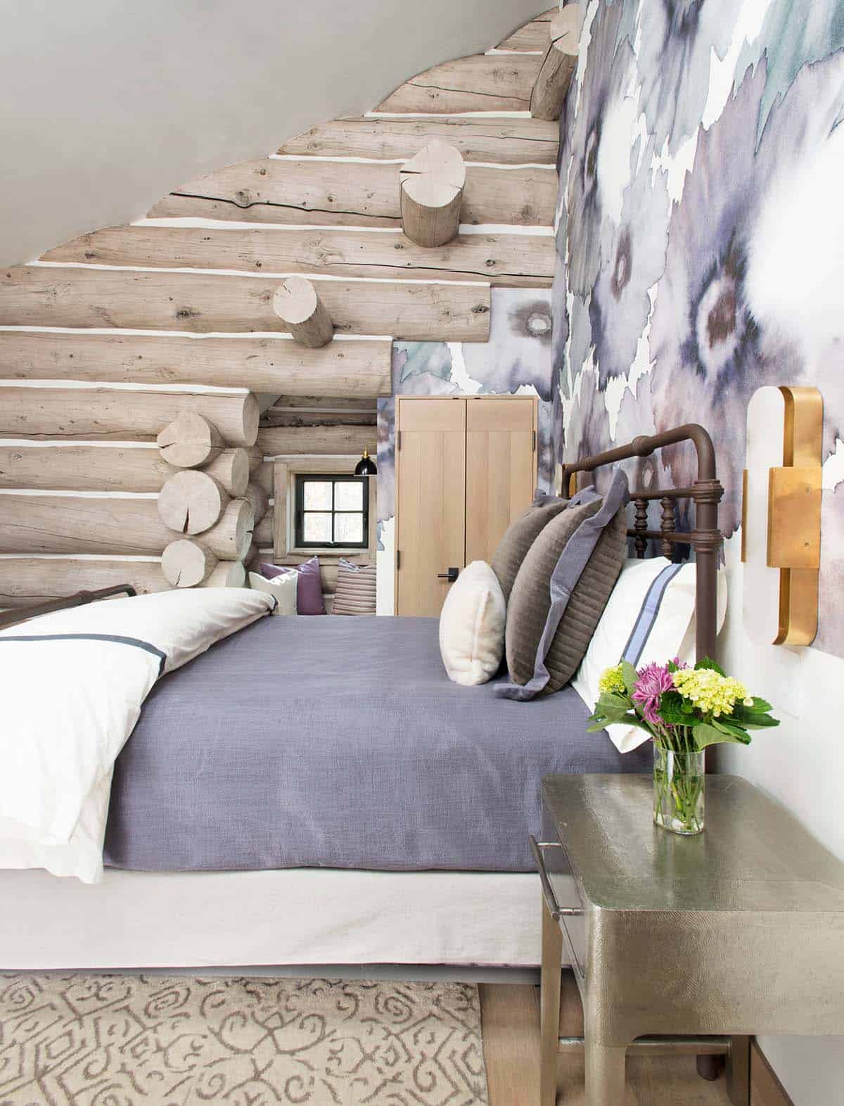 Loft bedroom with log ceiling and watercolor-print accent wall
