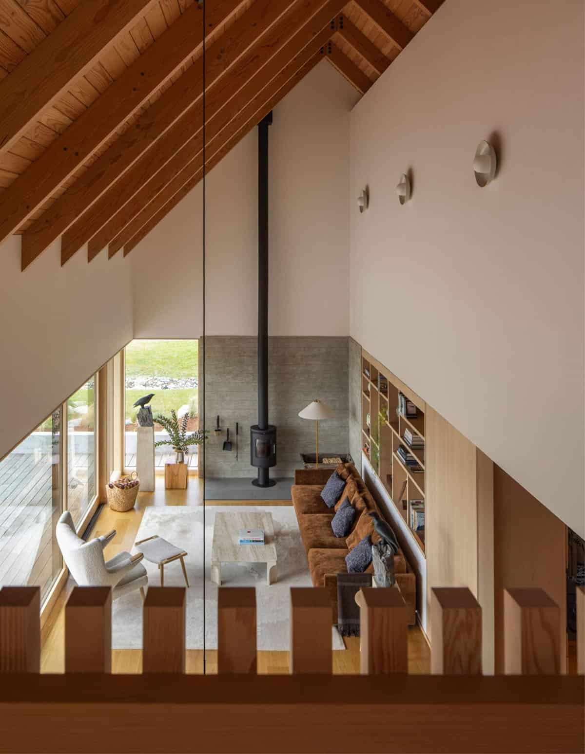 Elevated view of living room from loft showing vaulted ceiling and stove