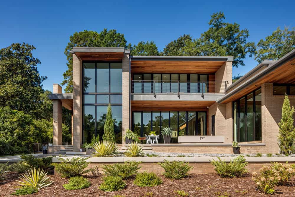Rear facade with cantilevered wood-clad balcony and floor-to-ceiling windows