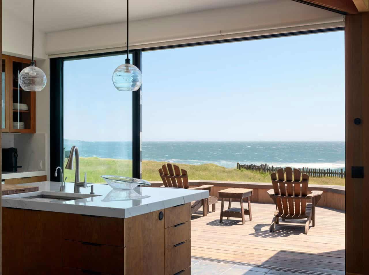 Kitchen sink overlooking rear deck and ocean horizon