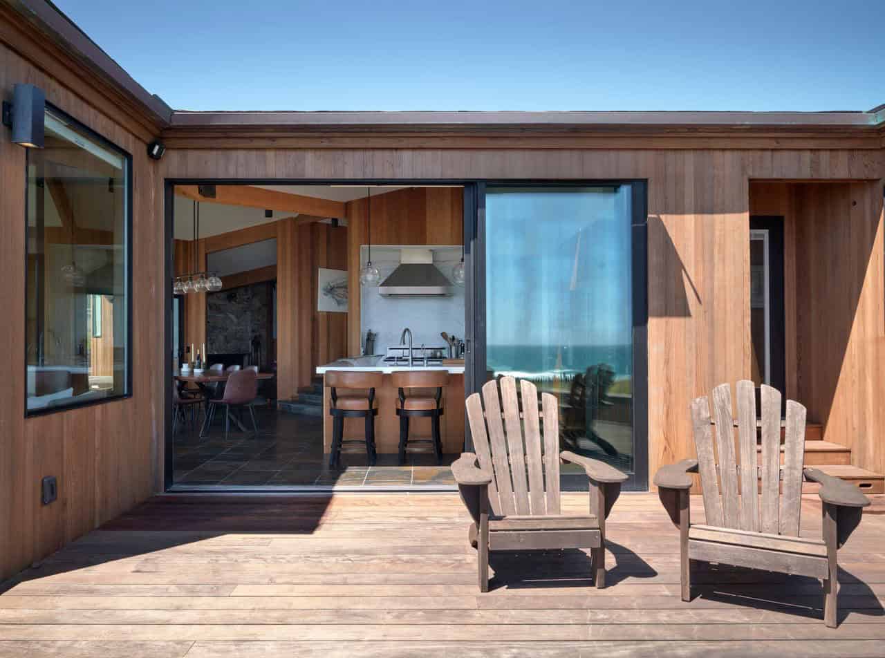 Rear deck with Adirondack chairs and kitchen view through sliding glass