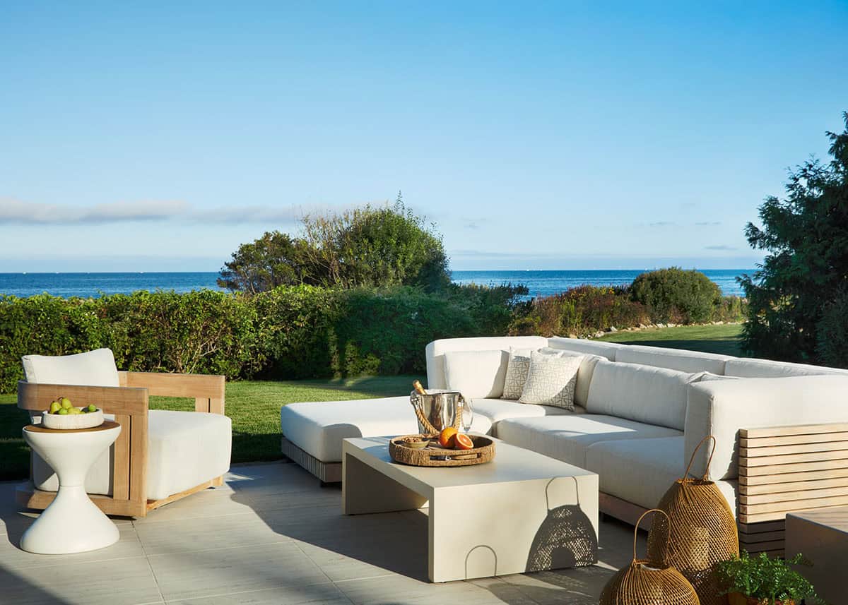 Outdoor lounge with white sectional overlooking the ocean
