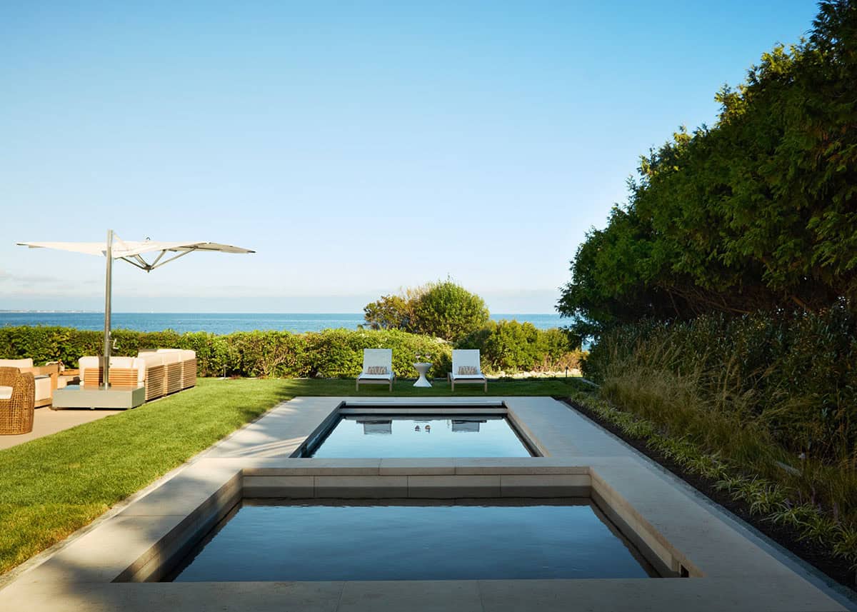 Tiered swimming pool and spa with ocean views beyond