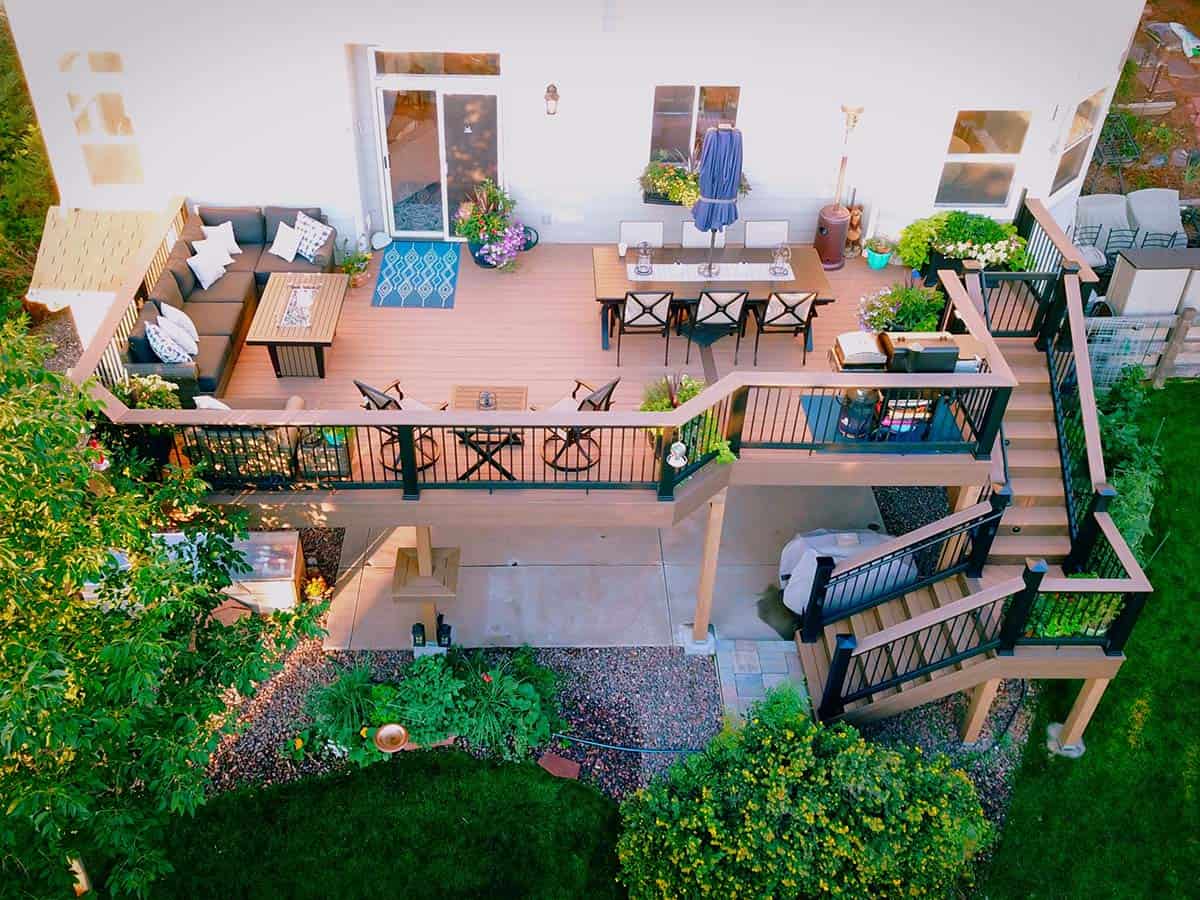 Aerial view of second-story composite deck with lounge, dining, and stair areas in Littleton, Colorado