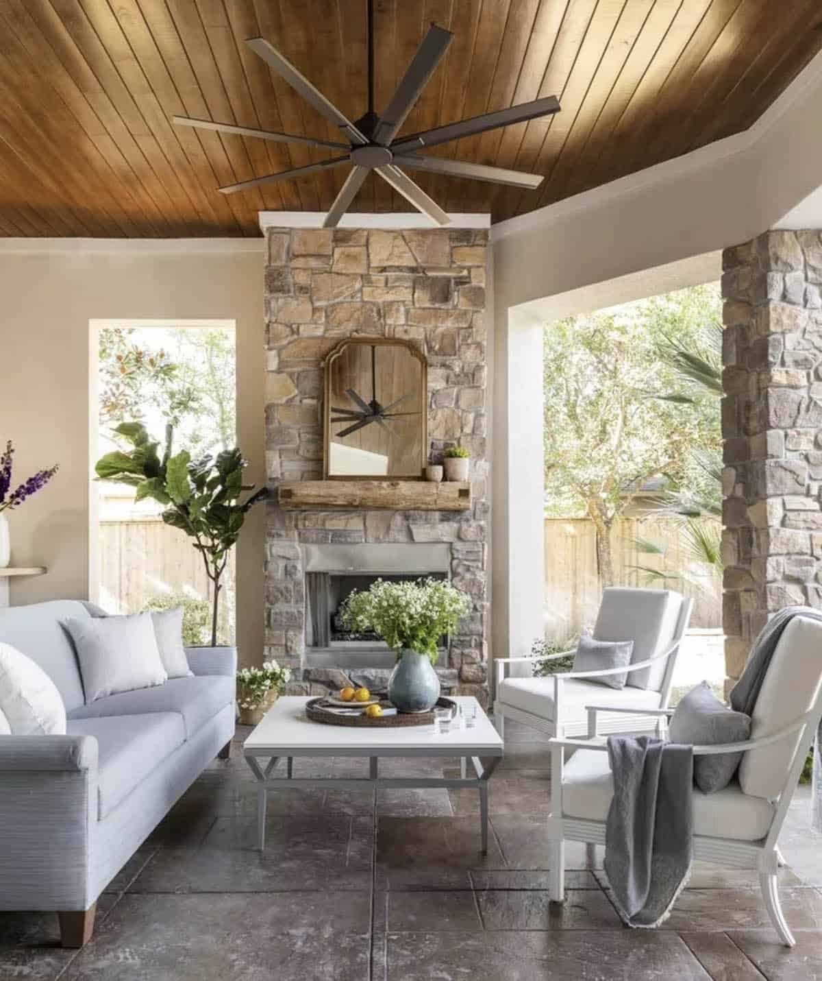 Stone fireplace with a vintage mirror propped on a wood mantel