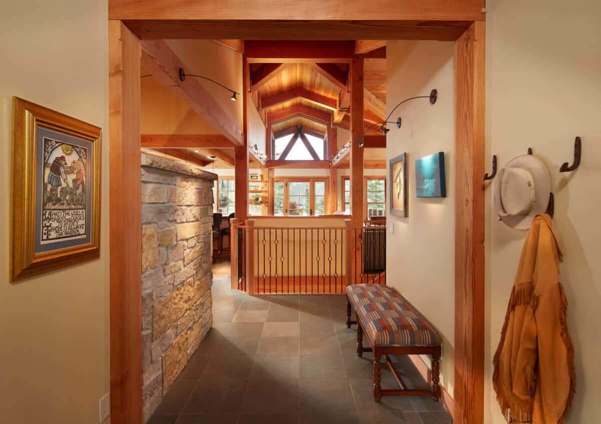 Timber-framed hallway with stone accent wall and upholstered bench