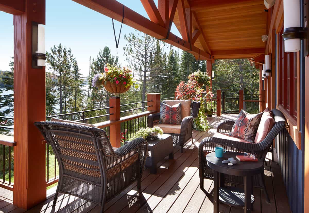 Screened deck seating area with hanging flower baskets and lake view