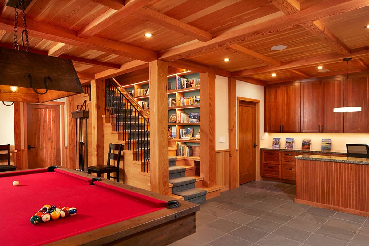 Game room with pool table, built-in bookshelves, and staircase