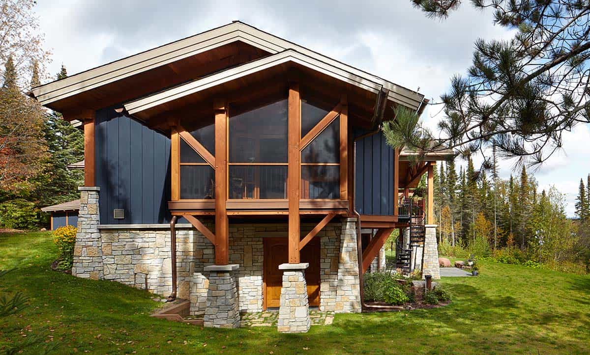 Timber-framed home exterior with stone foundation and screened porch