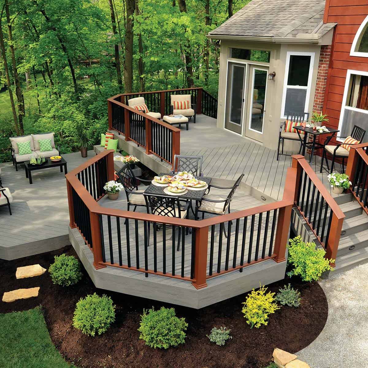 Multi-level composite deck with angled octagonal dining nook and forest view
