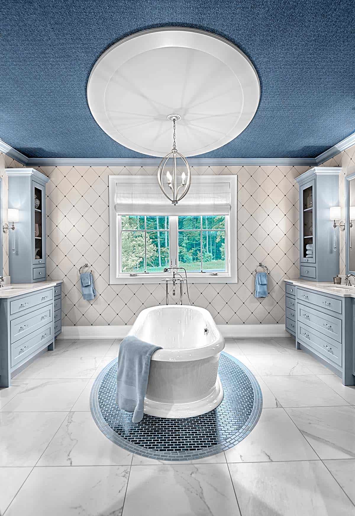 Primary bathroom with a freestanding tub beneath a domed light fixture and blue ceiling